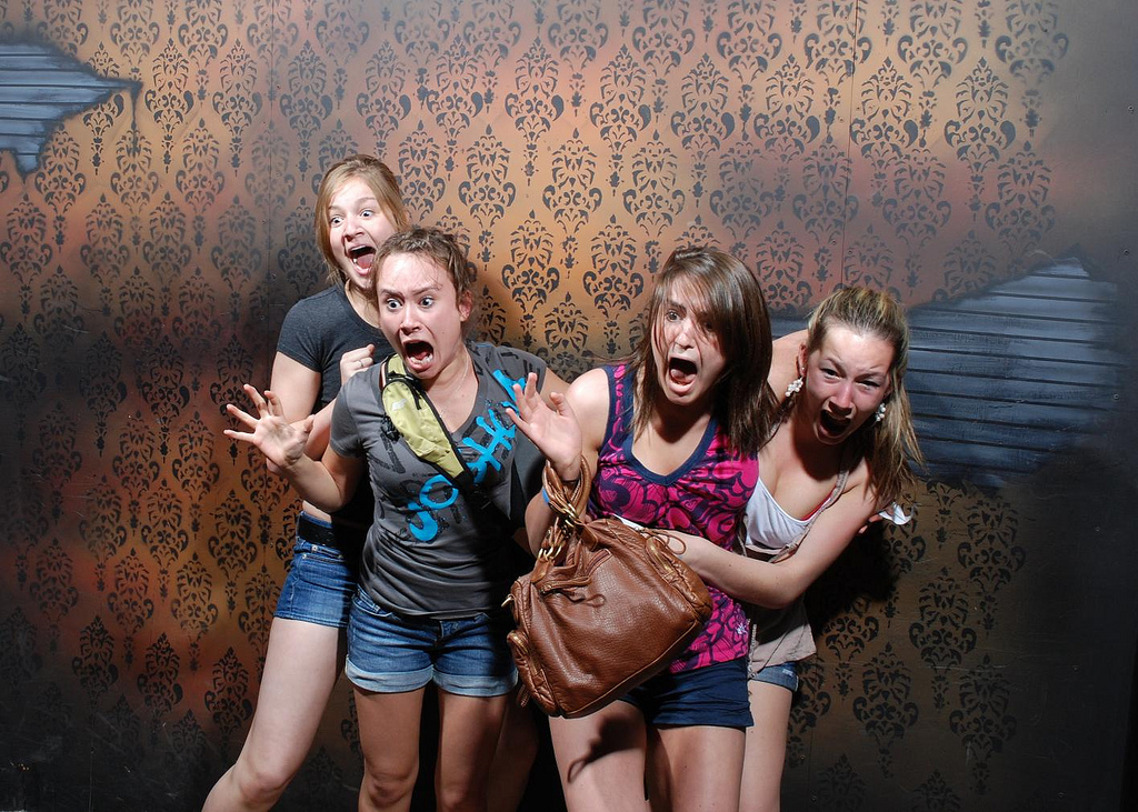 Scared people in a haunted house attraction