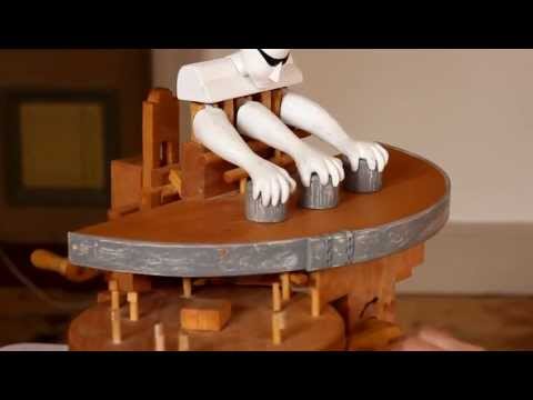 Une machine en bois qui joue au jeu des gobelets