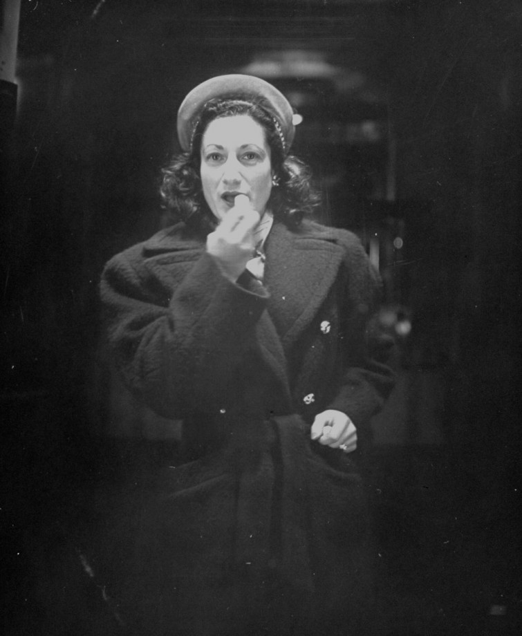 Woman applying lipstick in front of trick mirror i